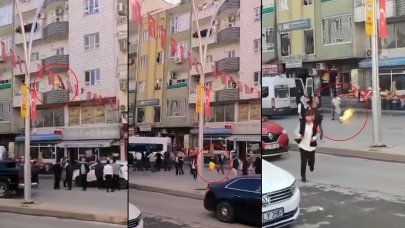 Panik anları: Alev alan tüpü, balkondan kalabalığın arasına attı