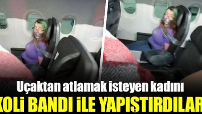 Uçaktan atlamak isteyen kadını koli bandı ile bağladılar