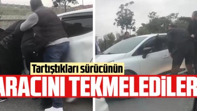 Tartıştıkları kişinin aracını tekmelediler