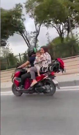 Kucağında çocukla motosiklette tehlikeli yolculuk