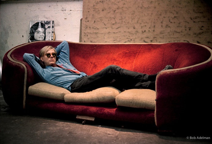 bob-adelman-andy-warhol-on-the-factory-couch-from-the-1964-film-couch-with-jackie-on-back-wall-1965.jpg